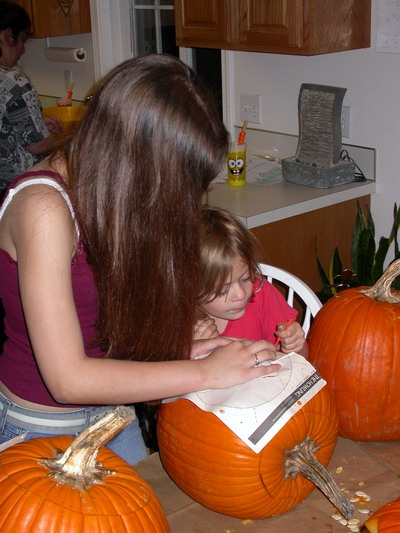 Sara and Kayla Carving Pumpkins Sara and Kayla Carving Pumpkins by Josh Poulson